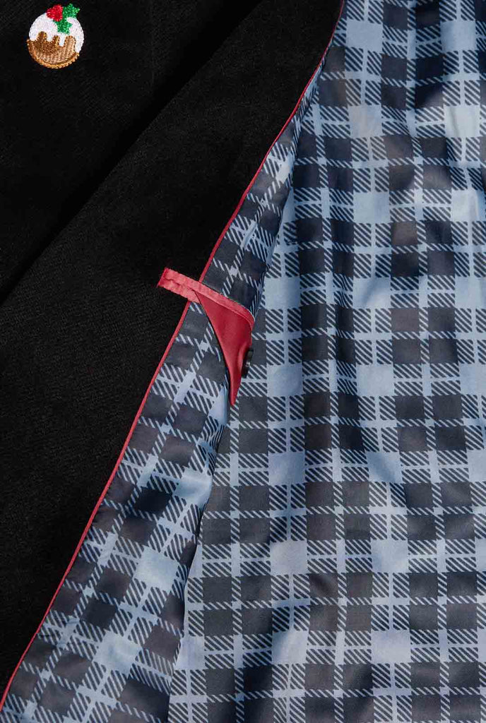 Man wearing burgundy red velvet Christmas blazer with Christmas icons, close up inside