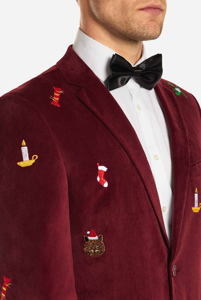 Man wearing burgundy red velvet Christmas blazer with Christmas icons, close up