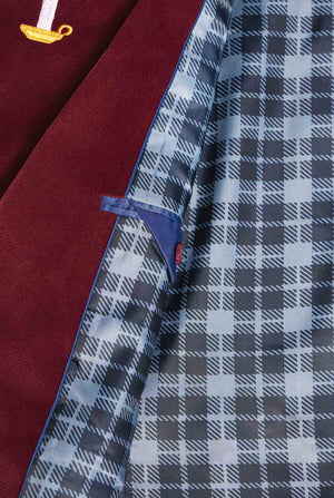 Man wearing burgundy red velvet Christmas blazer with Christmas icons, close up inside