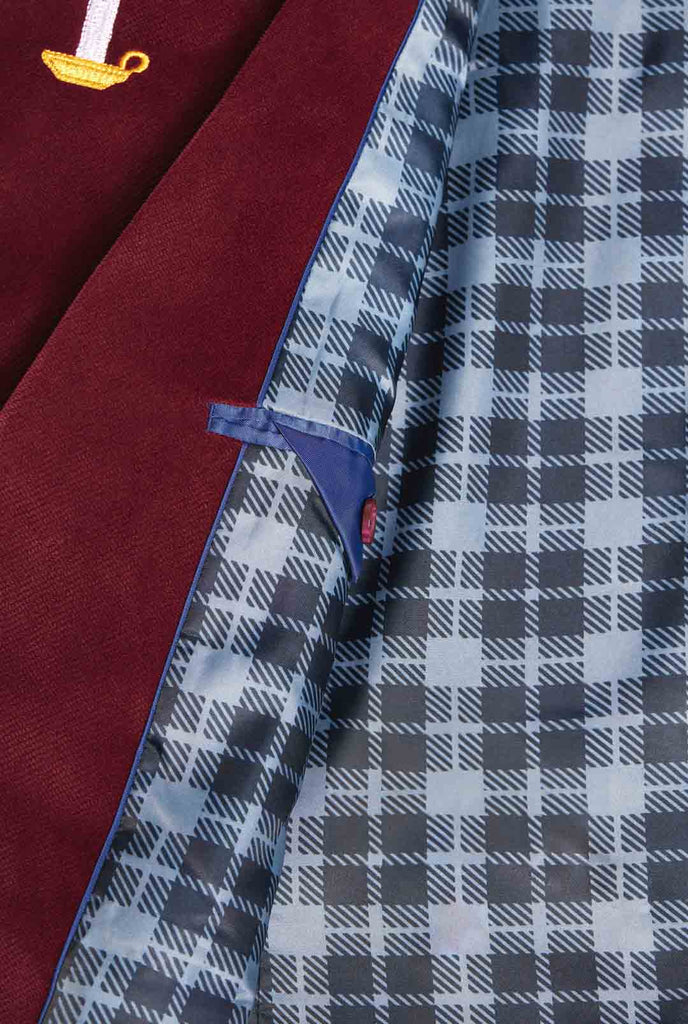Man wearing burgundy red velvet Christmas blazer with Christmas icons, close up inside