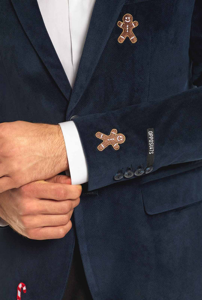 Man wearing navy blue Christmas blazer with Christmas embroidery, close up