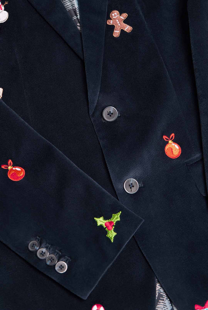 Man wearing navy blue Christmas blazer with Christmas embroidery, close up