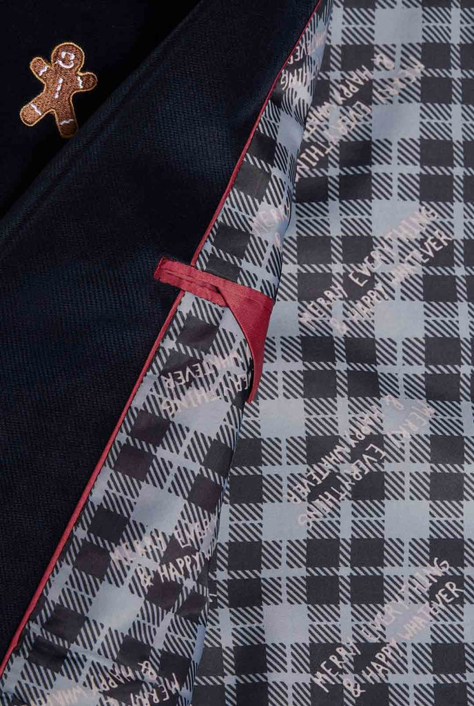 Man wearing navy blue Christmas blazer with Christmas embroidery, close up inside