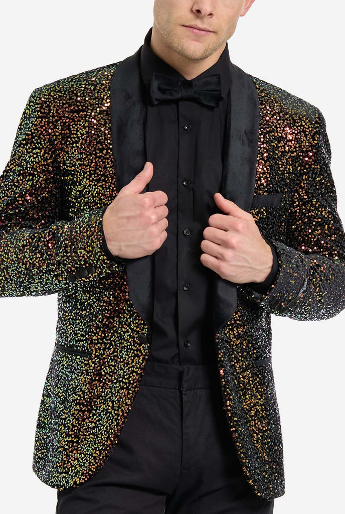 This image showcases a stylish men’s dinner jacket from OppoSuits Deluxe collection, featuring dazzling amber sequins that create a shimmering effect. The sequin blazer has a sleek satin lapel, a tailored fit. The model pairs it with a classic black dress shirt and bow tie, making this jacket perfect for formal events, holiday parties, or New Year celebrations. Ideal for men who want to stand out with bold, luxurious, and festive attire. Chest close up.