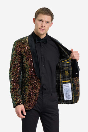 This image showcases a stylish men’s dinner jacket from OppoSuits Deluxe collection, featuring dazzling amber sequins that create a shimmering effect. The sequin blazer has a sleek satin lapel, a tailored fit. The model pairs it with a classic black dress shirt and bow tie, making this jacket perfect for formal events, holiday parties, or New Year celebrations. Ideal for men who want to stand out with bold, luxurious, and festive attire. Holding a side of the jacket open.