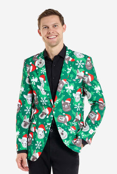 Man wearing green Christmas blazer for men with Christmas llamas. Man also wearing a black pants and black men's shirt.