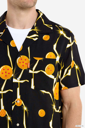 Man wearing black Hawaiian shirt with Dragon Ball Z print, showing Dragon Balls and lightning. Chest close-up.