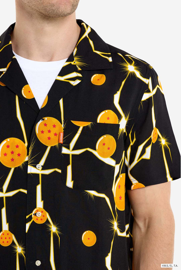 Man wearing black Hawaiian shirt with Dragon Ball Z print, showing Dragon Balls and lightning. Chest close-up.