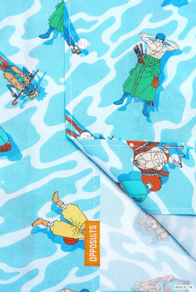 Blue Hawaiian shirt with One Piece character print. Button close up.