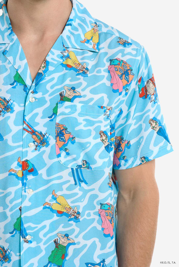 Man wearing blue Hawaiian shirt with One Piece character print. Chest close up.
