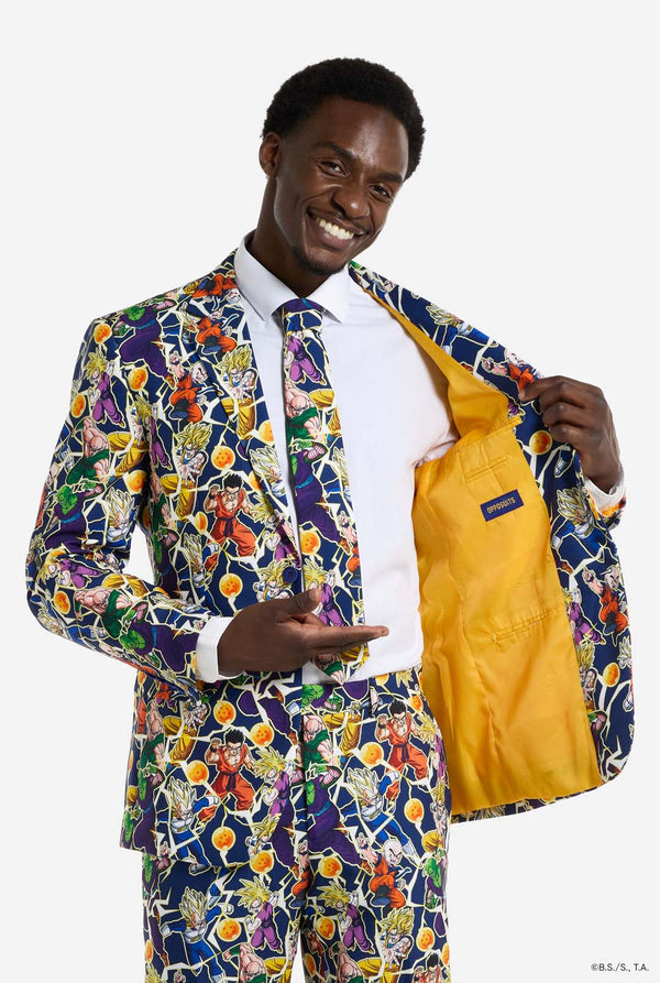 Man wearing all over print men's suit with Dragon Ball Z print which shows the Dragon Ball characters. Suit consists of Blazer, pant and tie. Man holding one side of the blazer open.
