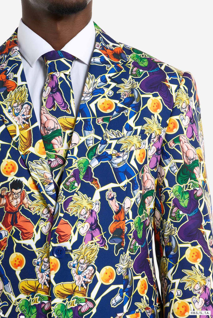 Man wearing all over print men's suit with Dragon Ball Z print which shows the Dragon Ball characters. Suit consists of Blazer, pant and tie. Chest close up.
