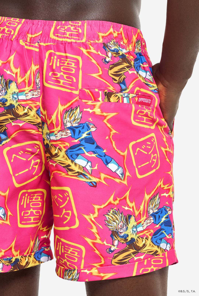 Man wearing pink summer set consisting of shirts and shorts. Summer set has Dragon Ball Z Goku and Vegeta fighting print. Back of shorts close up.