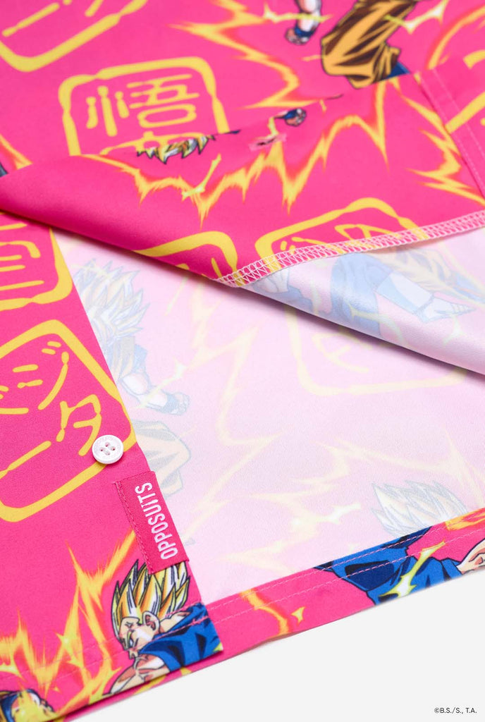 Image of pink summer set consisting of shirts and shorts. Summer set has Dragon Ball Z Goku and Vegeta fighting print. Bottom of shirt close up.