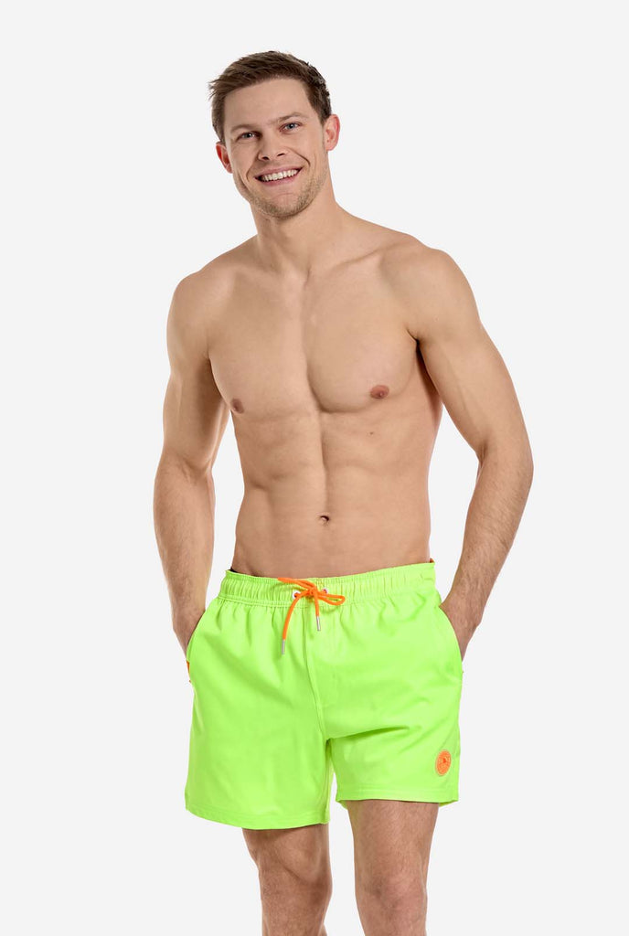 Man wearing Neon lime green swim trunks for men