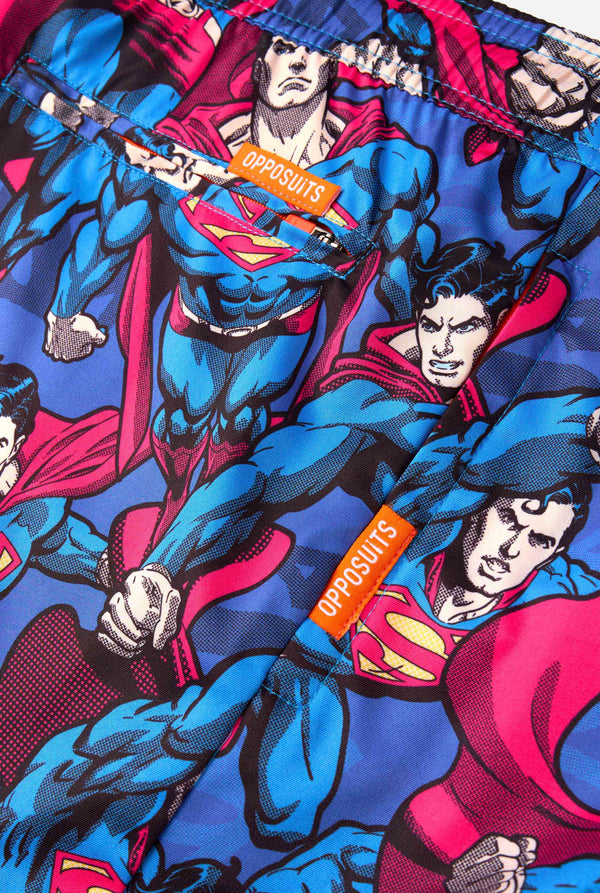 Men's Superman-themed swim shorts featuring a bold comic book design with multiple action poses of the Man of Steel. Perfect for superhero fans looking to make a splash. Close-up pockets.