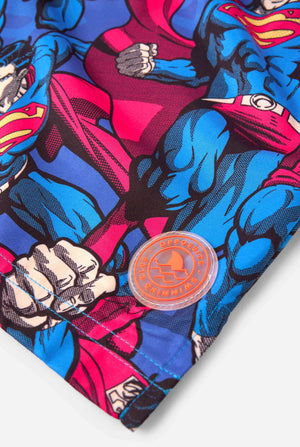 Men's Superman-themed swim shorts featuring a bold comic book design with multiple action poses of the Man of Steel. Perfect for superhero fans looking to make a splash. Close-up patch.