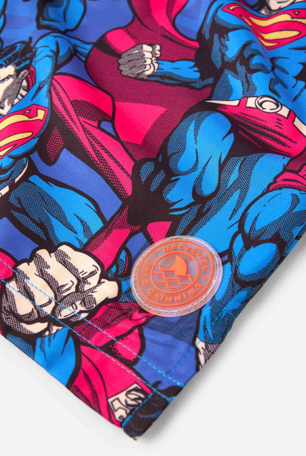 Men's Superman-themed swim shorts featuring a bold comic book design with multiple action poses of the Man of Steel. Perfect for superhero fans looking to make a splash. Close-up patch.