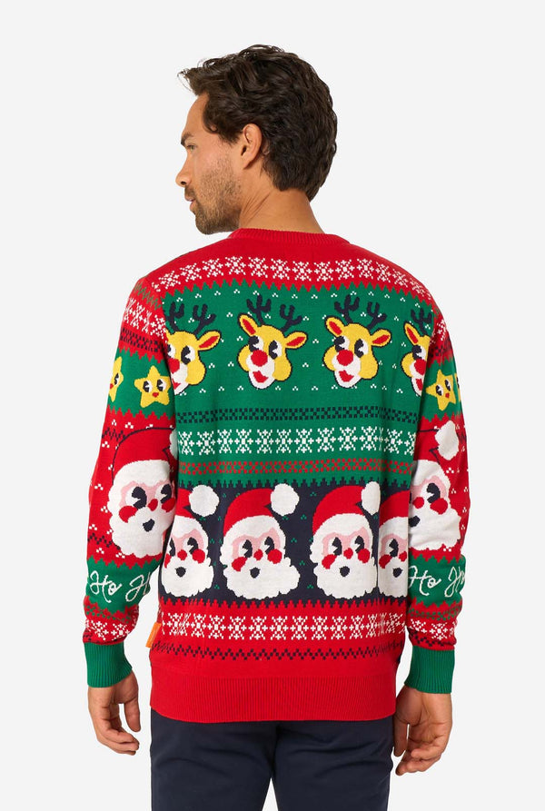 Man wearing a festive Christmas sweater with reindeer and Santa Claus designs.