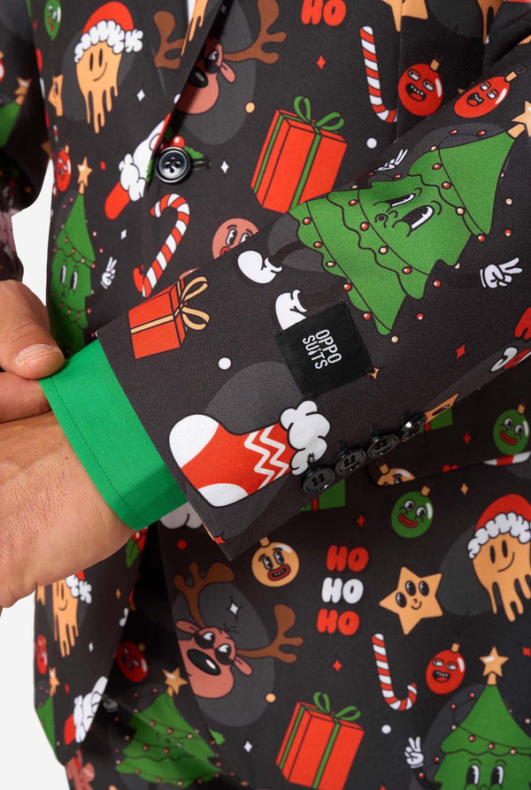 Black bag with Christmas-themed design held by a hand