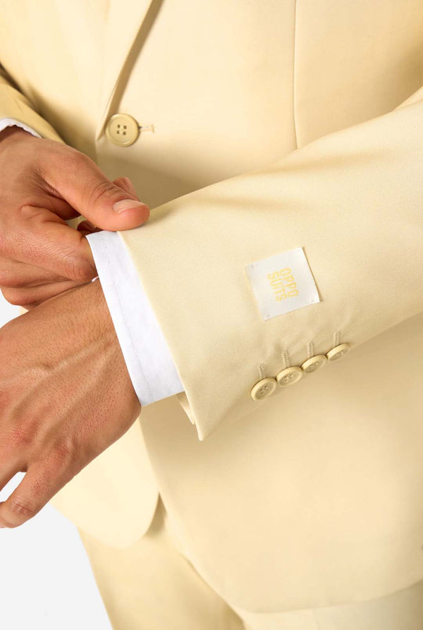 Elegant men's suit in a soft pastel yellow shade, perfect for weddings, summer events, and formal occasions. This stylish tailored suit features a slim fit design, notch lapels, and a matching tie for a sophisticated look. Ideal for modern gentlemen looking to make a statement with a light-colored pastel suit. Close-up sleeve.