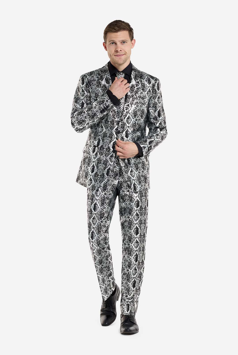 A man is wearing an eye-catching silver and black snake-print suit by OppoSuits. The striking suit features a bold snakeskin pattern, offering a sleek, fashionable look perfect for parties, events, or making a daring fashion statement. The men suit is paired with a black dress shirt and a matching snake-print tie, adding a sophisticated edge to the overall ensemble. The man's confident smile and formal yet modern outfit give off a high-fashion, stylish vibe.