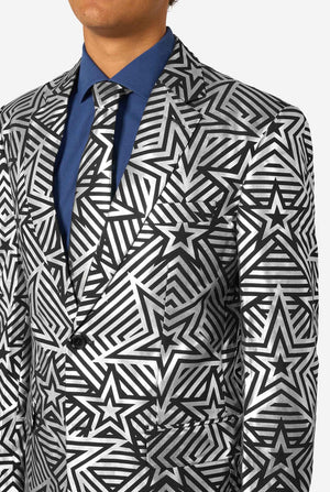 Close-up of upper torso showing intricate black and silver geometric star pattern on blazer and matching tie.