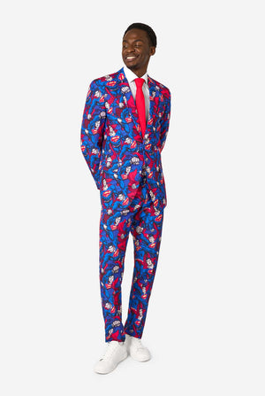 A man wearing a Superman themed suit with a red tie and a white shirt on a white background. Full body image