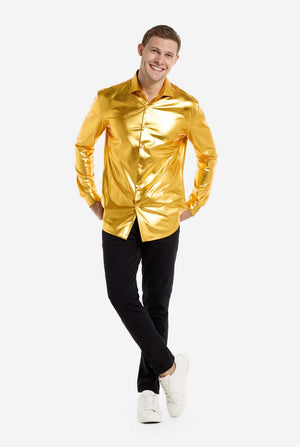 Person wearing a shiny gold shirt and black pants on a white background