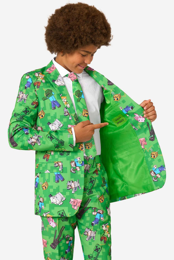Teen boy wearing a bright green Minecraft suit with iconic characters, including Creepers and Steve – Holding his jacket open