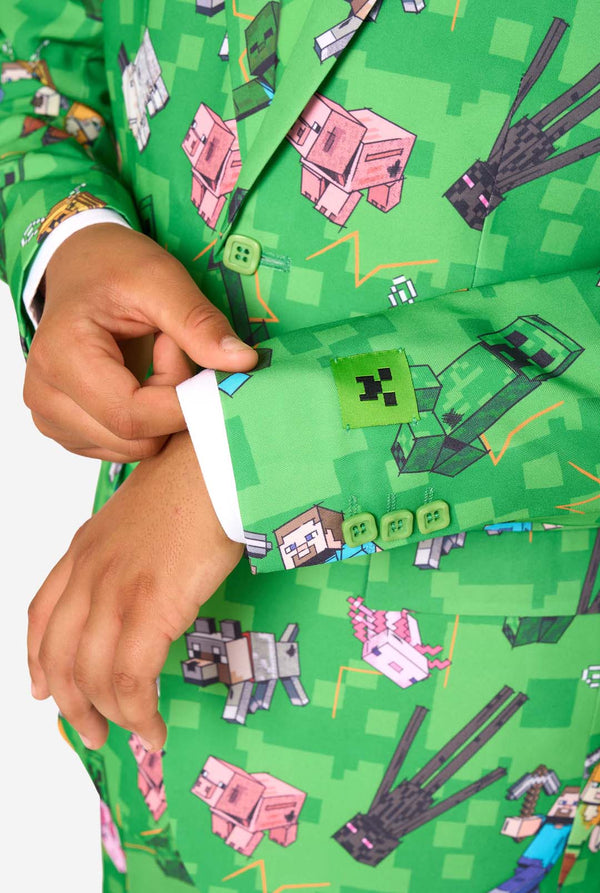 Teen boy wearing a bright green Minecraft suit with iconic characters, including Creepers and Steve – Close up of the sleeves