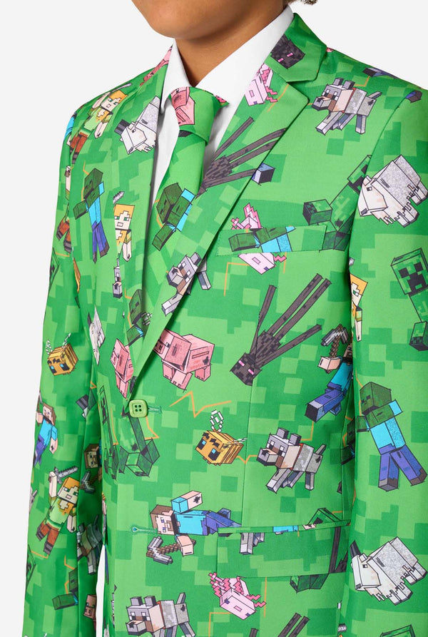 Teen boy wearing a bright green Minecraft suit with iconic characters, including Creepers and Steve – Close up of the chest