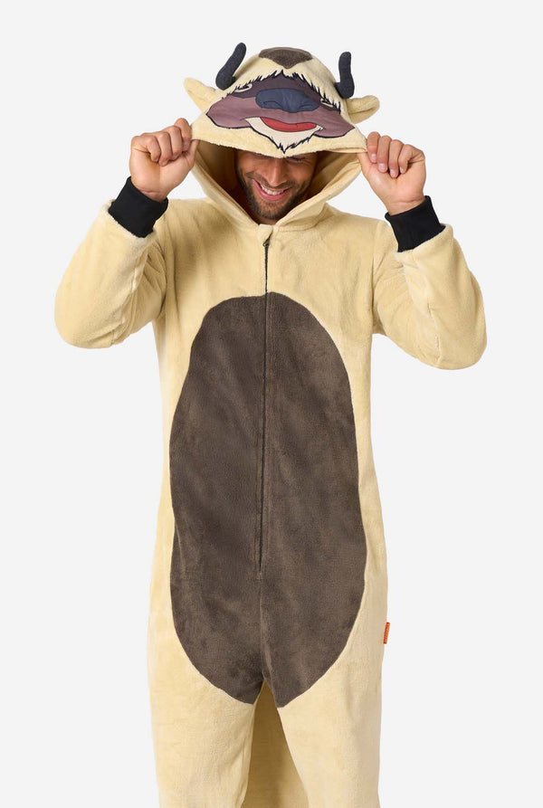 Man wearing a beige and brown fleece Appa onesie with hood featuring Appa’s face, horns, and brown belly patch.