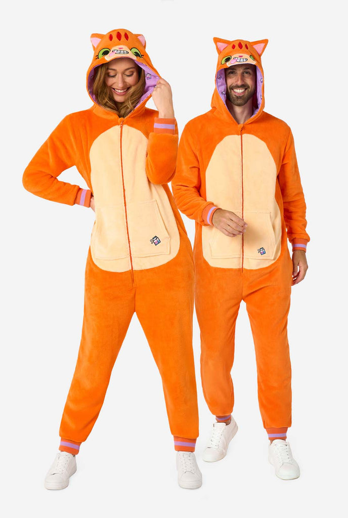 A man and women are wearing an orange adult onesie designed as a red cat onesie. The onesie features a hood resembling a cat's head, and cat details, perfect for cozy lounging or costume parties. Both have the hood on their head. Full body image.