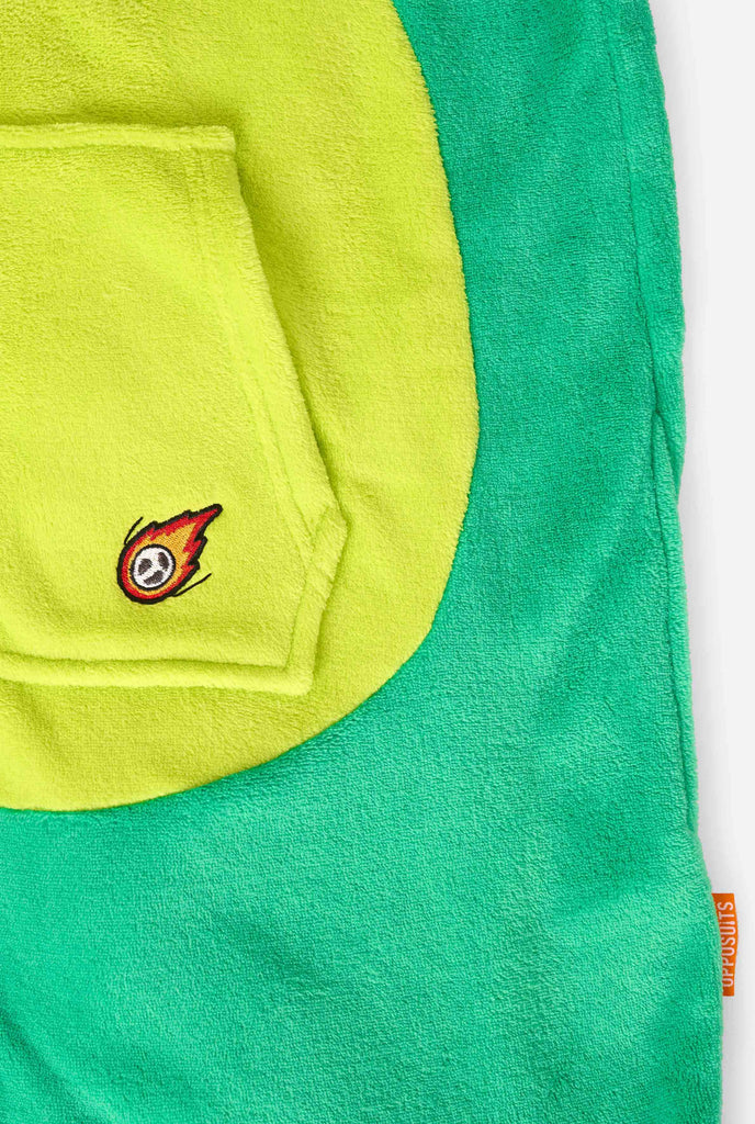 Kid is wearing green dino onesie for kids. Close up.