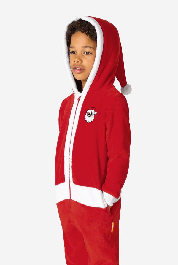 Kid is wearing a red Christmas Santa onesie, resembling a Santa suit with a hood and santa logo.