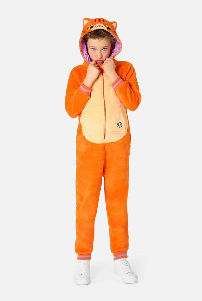 Child wearing a playful unisex kids onesie designed as a red-orange cat, featuring a hood with a cartoon cat face, ears, and a light beige belly panel, making a silly face against a plain background.