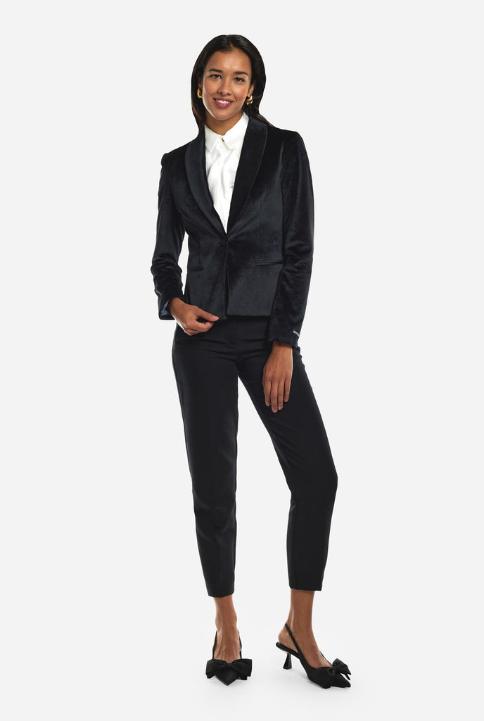 Woman wearing golden velvet dinner jacket blazer