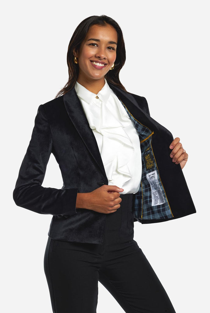 Woman wearing golden velvet dinner jacket blazer