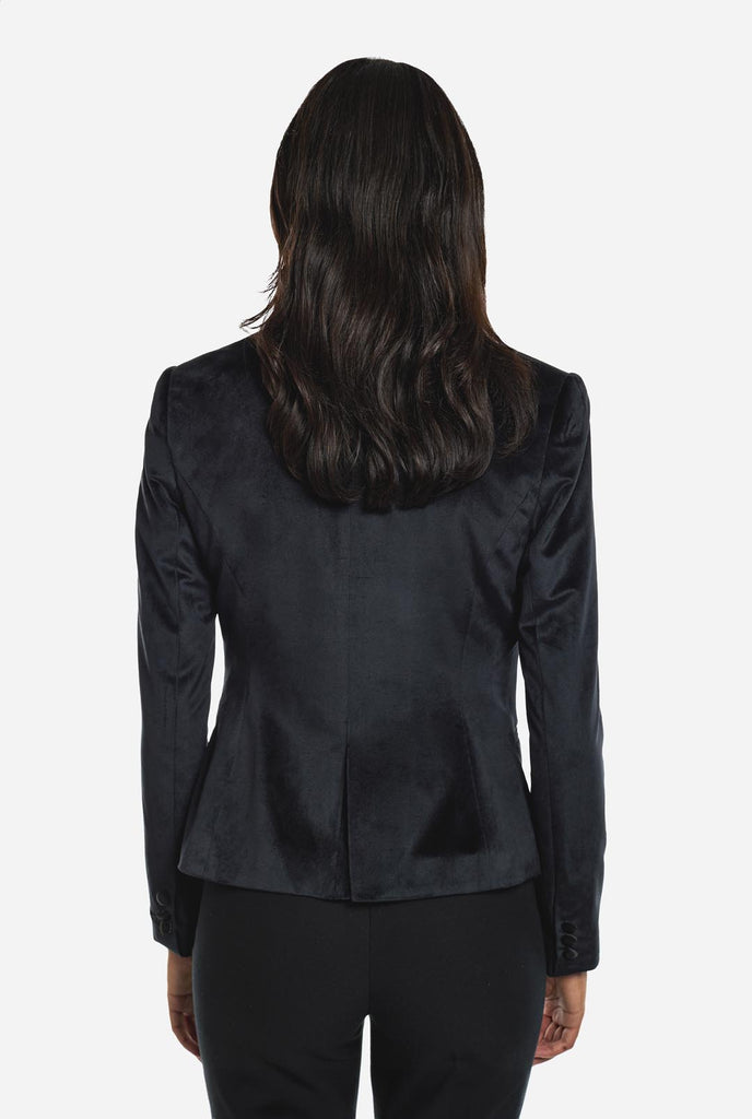 Woman wearing golden velvet dinner jacket blazer