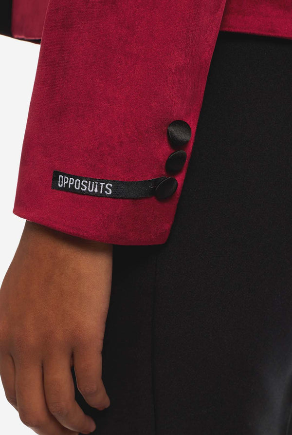 Woman wearing burgundy red velvet dinner jacket blazer