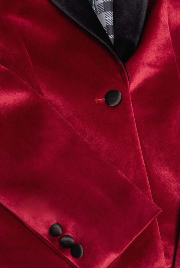 Woman wearing burgundy red velvet dinner jacket blazer