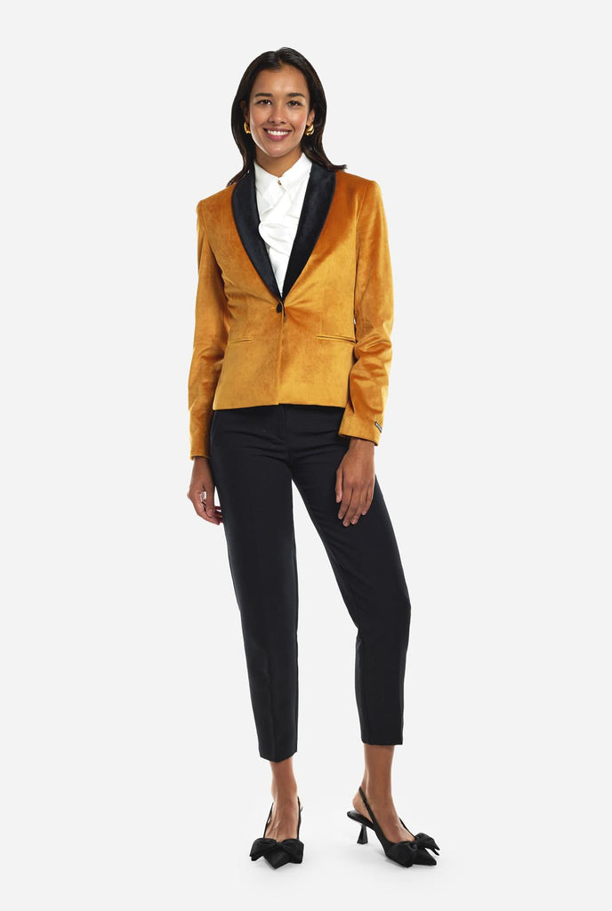 Woman wearing golden velvet dinner jacket blazer