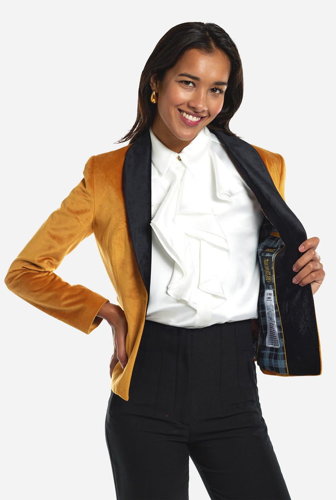 Woman wearing golden velvet dinner jacket blazer