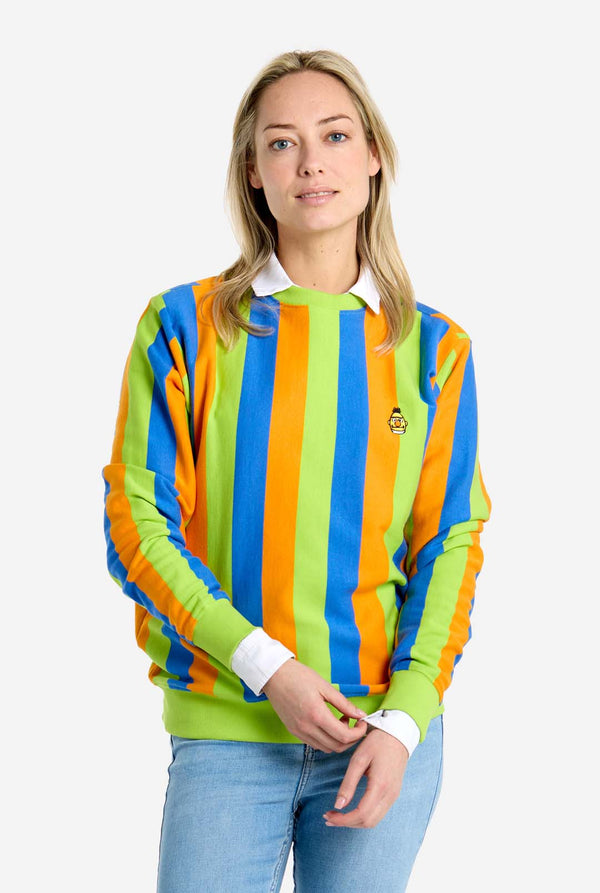 Woman wearing a colorful striped sweater with a plain background