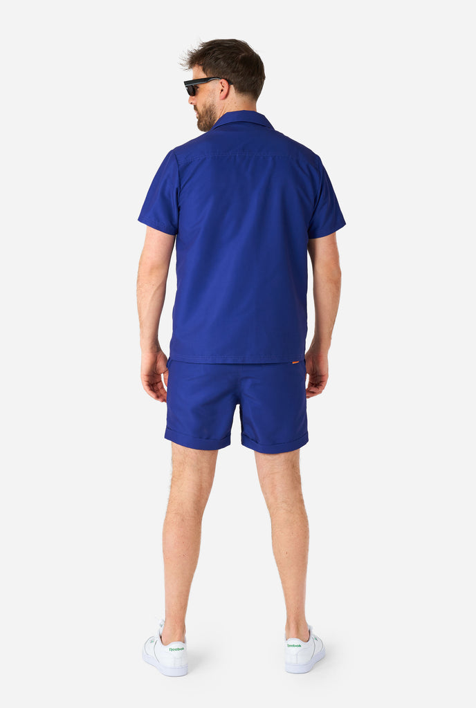 Man wearing blue summer set consisting of shirt and shorts