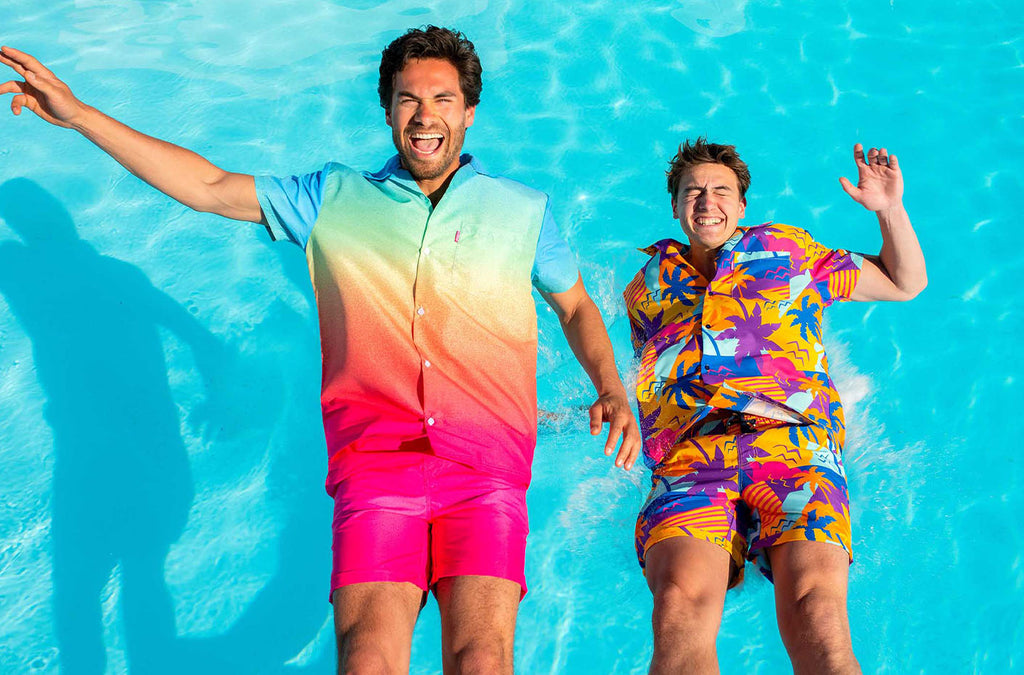 two men wearing summer sets and falling in pool