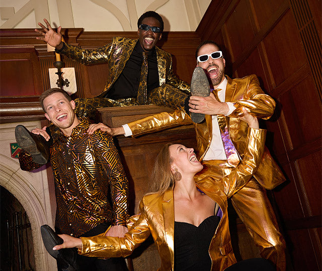 An image of 4 people wearing golden products.
