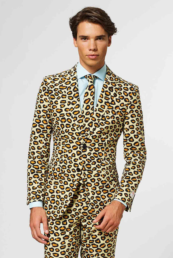 Video of man wearing The Jag men's suit with panther print, showing suit like a model. Suit consists of blazer, pant and tie.