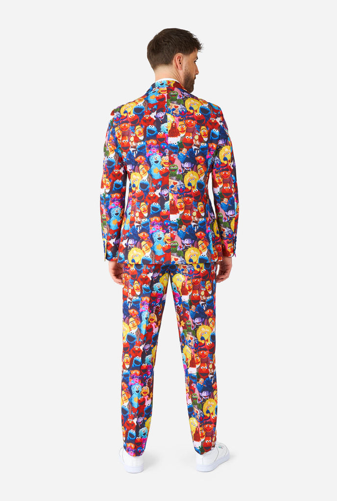 Man wearing men's suit with Sesame street characters print, view from the back